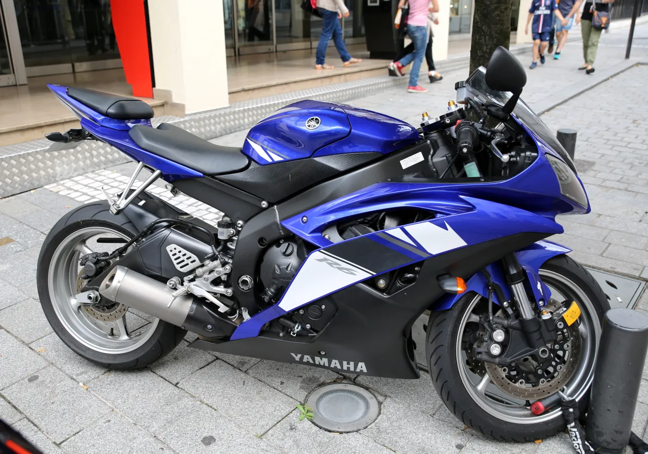 Blue Yamaha YZF-R6 sport motorcycle parked in daylight