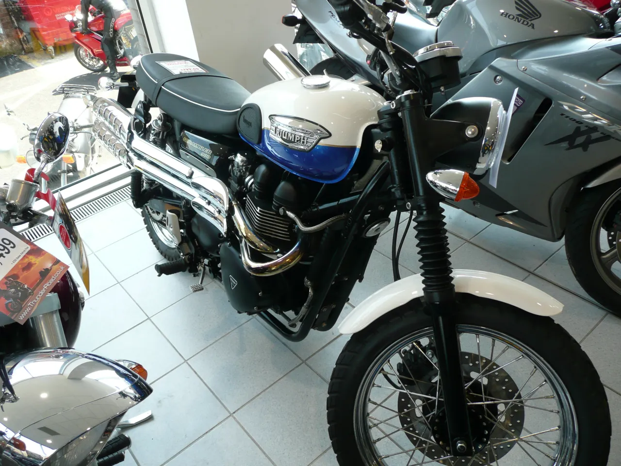 Triumph Scrambler 900 parked, showing high-level exhaust pipes