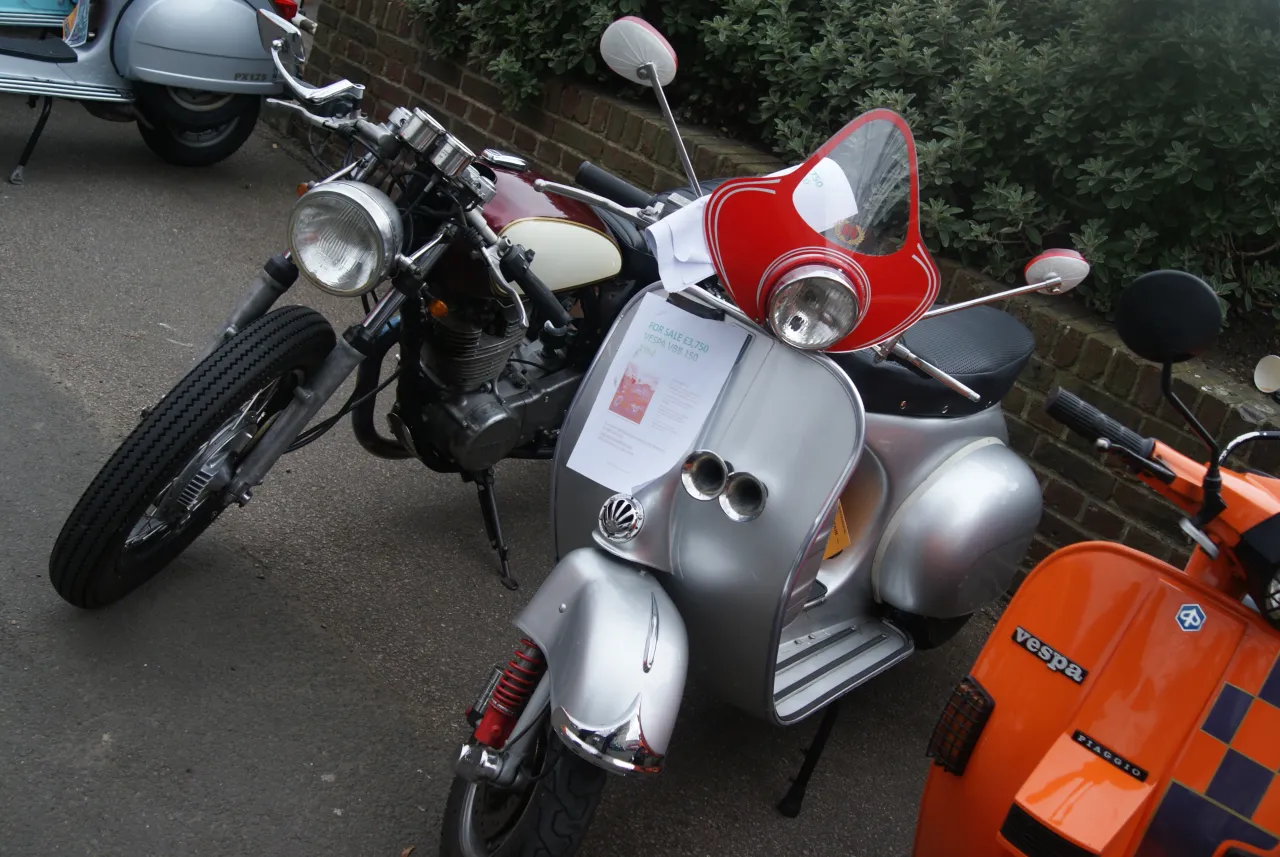 Vespa VBB 150 scooter at a classic vehicle event, side view